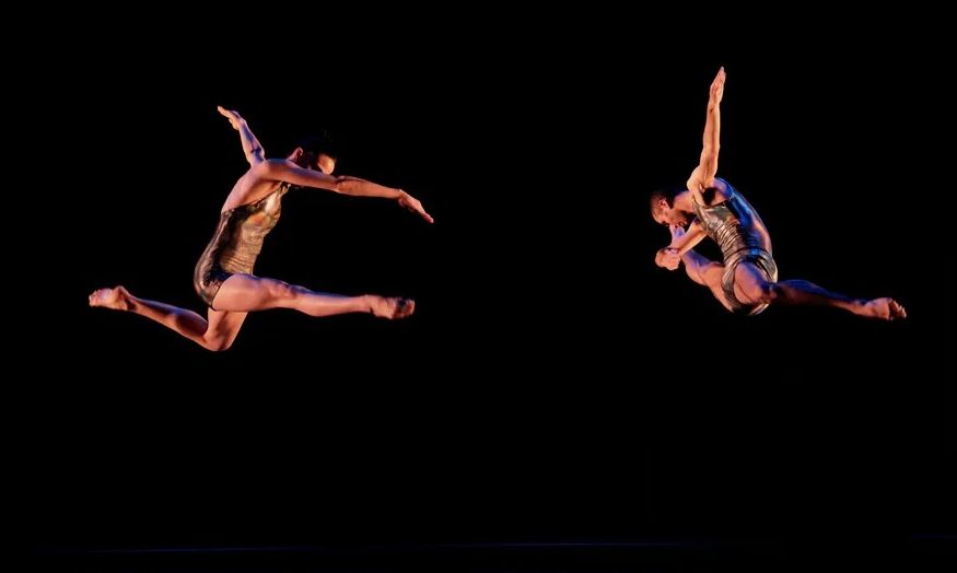 A couple of dancers performing on stage

Description automatically generated