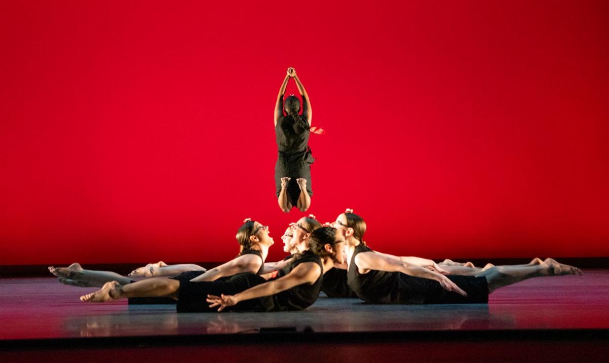 A group of dancers performing on stage

Description automatically generated