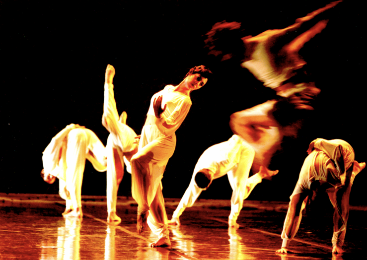 A group of people dancing on a stage

Description automatically generated