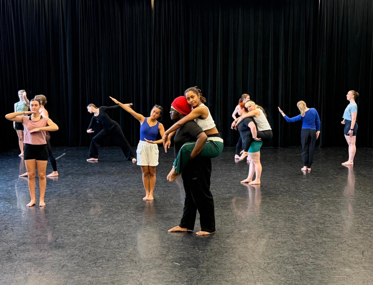 A group of people dancing on a stage

Description automatically generated