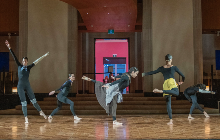 A group of women dancing on a stage

Description automatically generated