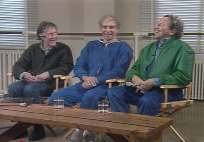 A group of men sitting in chairs

Description automatically generated